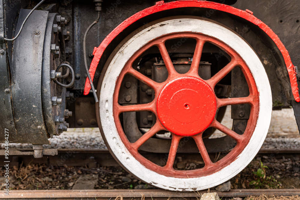 Rusty steam train wheel showing intricate details from an old locomotive in a picturesque setting Rusty steam train wheel showing intricate details from an old locomotive in a picturesque setting