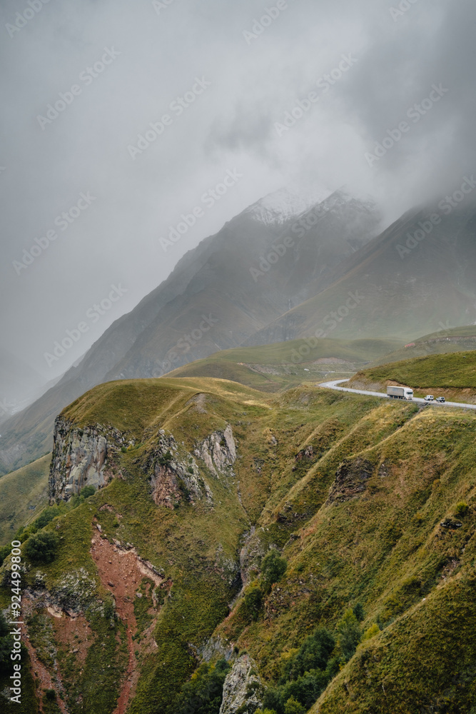 View of the mountains and landscapes surrounding the Georgian Military Highway near the Gudauri Pass, near the Russia -Georgia friendship monument on a foggy autumn day View of the mountains and landscapes surrounding the Georgian Military Highway near the Gudauri Pass, near the Russia -Georgia friendship monument on a foggy autumn day