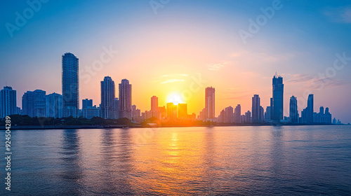 City skyline with the sun setting behind the buildings.