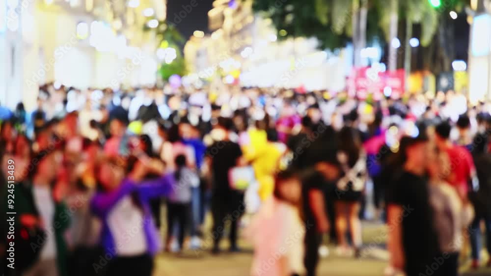 Defocused many people walking on the street at night Defocused many people walking on the street at night