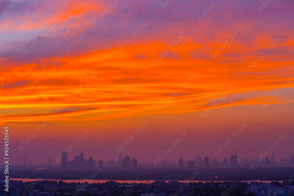 Evening view of city silhouettes of buildings and skyscrapers, the dying sky after sunset and amazing red clouds Evening view of city silhouettes of buildings and skyscrapers, the dying sky after sunset and amazing red clouds