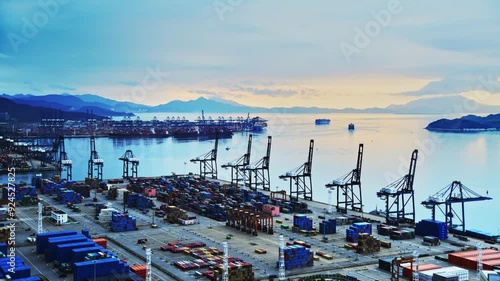 Time lapse of containers in a harbor at sunrise