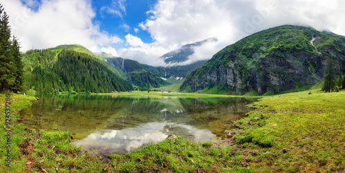 Beautiful summer lake landscape with mountain in the Autria Alps. Wonderful hiking spot. Alpine lake with high mountains. Pine trees. Hohe Tauern near Zell am See / Kaprun photo