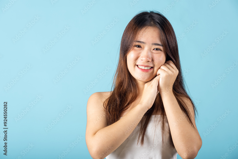 Skin care and Beauty concept. Portrait happy woman with natural makeup and healthy face studio shot isolated on blue background, Asian young female with beauty face touching healthy facial skin Skin care and Beauty concept. Portrait happy woman with natural makeup and healthy face studio shot isolated on blue background, Asian young female with beauty face touching healthy facial skin