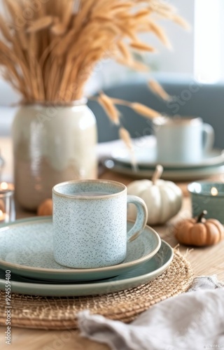 Elegant Autumn-Themed Dinner Table Setting With Candles and Decorative Pumpkins