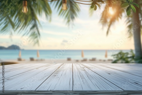 Fototapeta Naklejka Na Ścianę i Meble -  White wooden table in a tropical summer beach background with blurred blue sea, palm trees, and light bulbs. Ideal for product display in a warm, sunny environment.