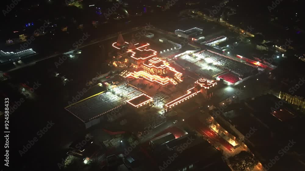 Aerial night view of Ayodhya Ram Temple, a temple illuminated by glowing lights, standing out in the dark surroundings. Famous historical place in India Aerial night view of Ayodhya Ram Temple, a temple illuminated by glowing lights, standing out in the dark surroundings. Famous historical place in India