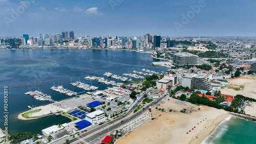 Fototapeta Naklejka Na Ścianę i Meble -  Aerial view of Luanda showcasing the coast, marina, and city skyline on a clear day