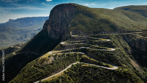 Winding Serra da Leba Road in Angola surrounded by lush mountains under a clear sky