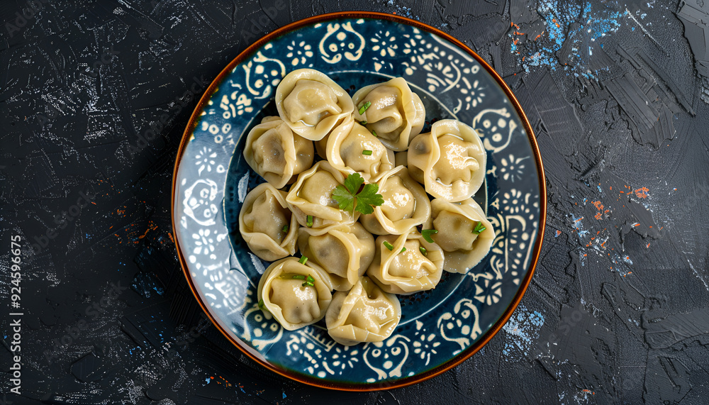 Plate of traditional russian pelmeni, ravioli or dumplings on black background, top view Plate of traditional russian pelmeni, ravioli or dumplings on black background, top view