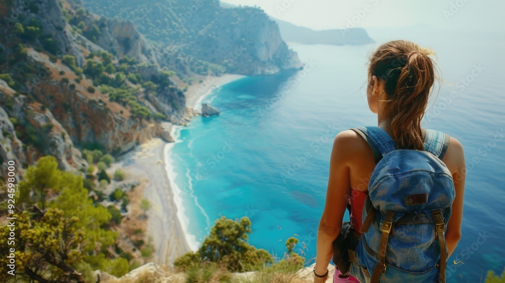 A woman standing by the ocean, looking out at the horizon A woman standing by the ocean, looking out at the horizon