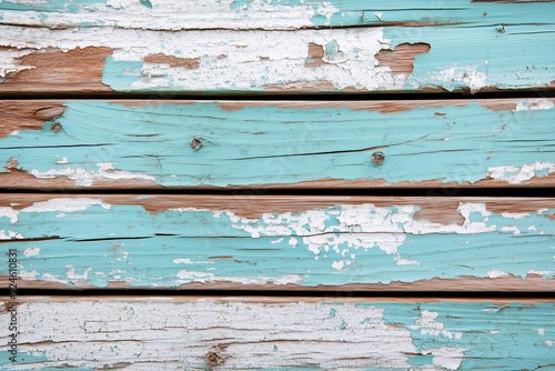 A detailed section of peeling paint on a rough wooden surface