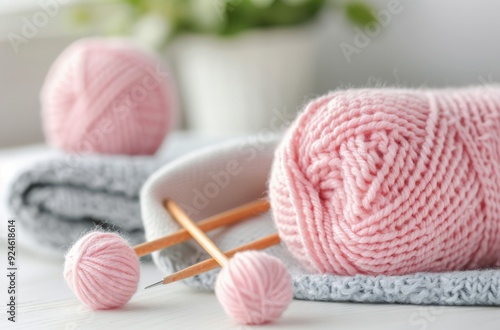 Pink Yarn Ball and Knitting Needles With Soft Knit Fabric