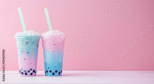 Two Colorful Bubble Teas with Straws on Pink Background