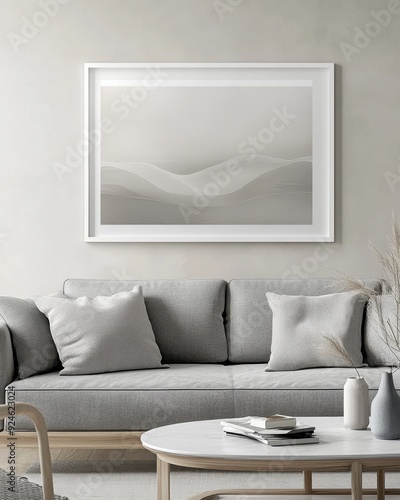 A white framed picture of a beach scene hangs on a wall