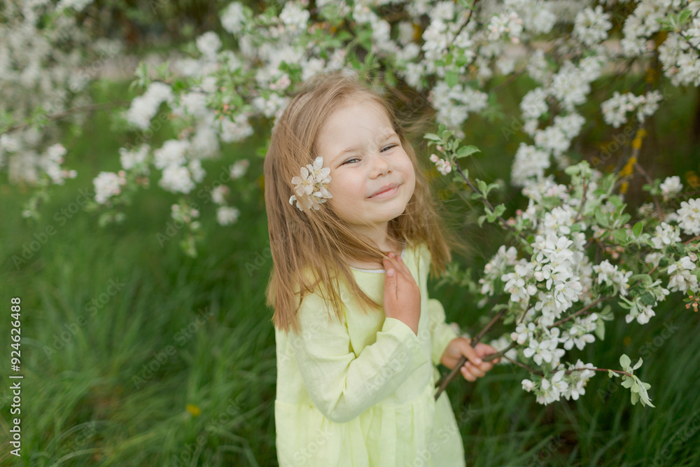 little girl in the spring field with flowering tree little girl in the spring field with flowering tree