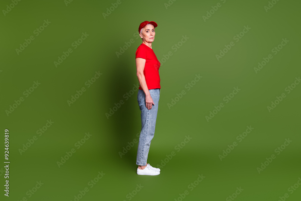 Full body photo of attractive mature woman professional delivery employee profile wear red uniform workwear isolated on khaki background Full body photo of attractive mature woman professional delivery employee profile wear red uniform workwear isolated on khaki background