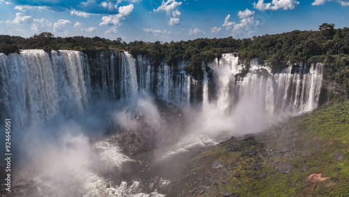 Kalandula Waterfall cascading majestically in Angola on a sunny day photo