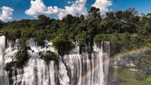 Kalandula Waterfall in Angola with a stunning rainbow under a bright blue sky photo