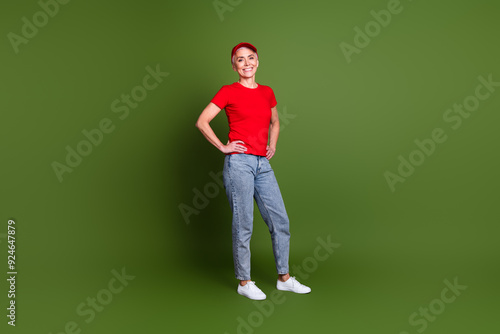 Full length photo of lovely pensioner lady delivery service employee confident dressed red uniform workwear isolated on khaki background