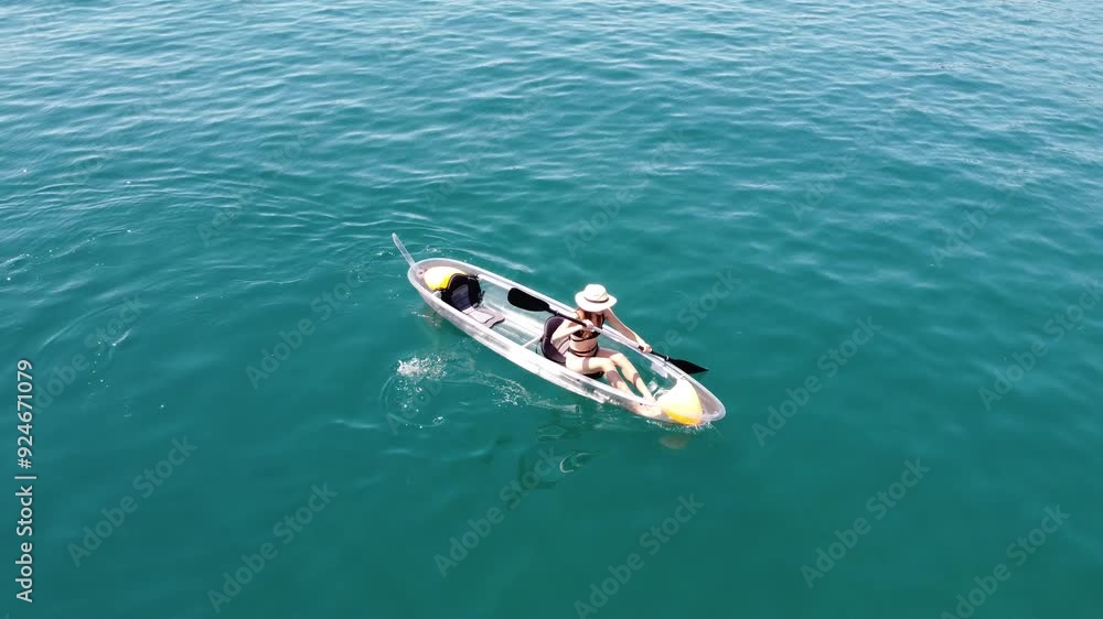 Woman in Black Swimsuit Kayaking in the Azure Waters of the Adriatic Sea near Rab Island, Croatia, 4k Woman in Black Swimsuit Kayaking in the Azure Waters of the Adriatic Sea near Rab Island, Croatia, 4k