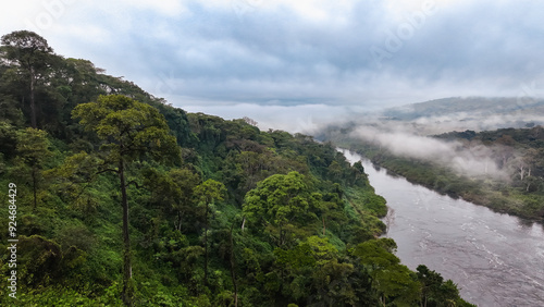 Misty river flowing through lush green landscape near Calandula Waterfall in Angola at dawn photo