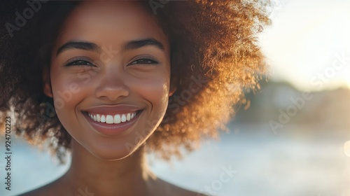 Woman smiling with confidence, her hair shining brightly, with ample space for copy