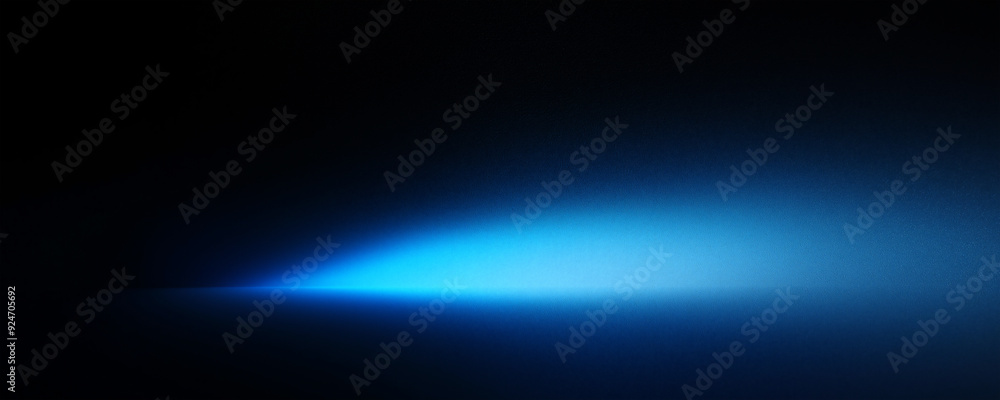 Fototapeta premium Abstract blue spotlight on a black background banner with empty space for text.