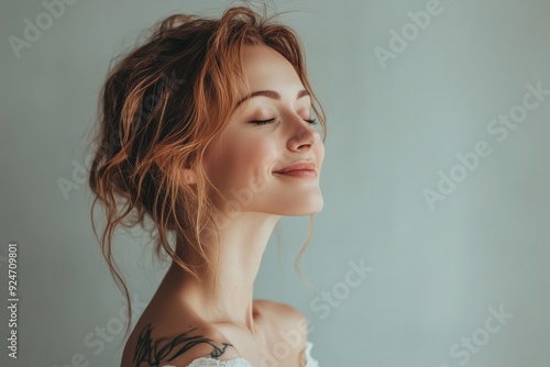 A close up of a woman's face with tattoos and her eyes closed