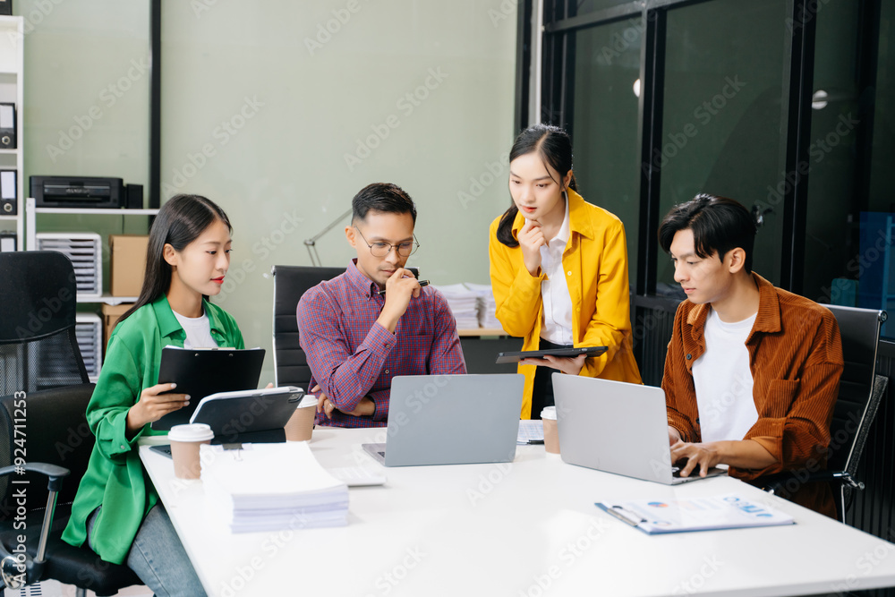 Happy businesspeople while collaborating on a new project in an office. Group of diverse businesspeople Happy businesspeople while collaborating on a new project in an office. Group of diverse businesspeople