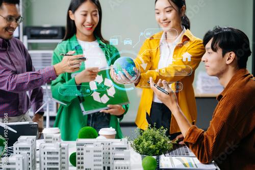 Group of diverse multiethnic businesspeople standing neare table looking at model of building from residential project. Green business company photo