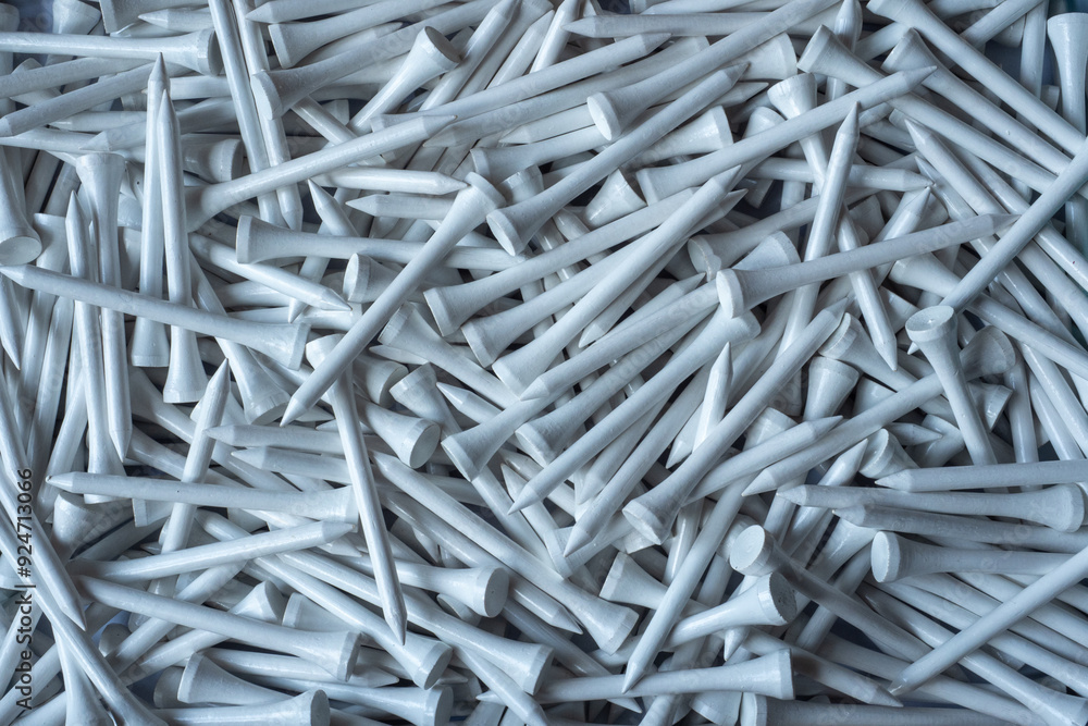 A large pile of white wooden bamboo golf tees in abox A large pile of white wooden bamboo golf tees in abox