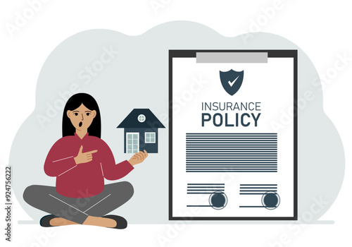 A woman holds in his hands at home next to a large insurance contract. Home and real estate insurance concept.