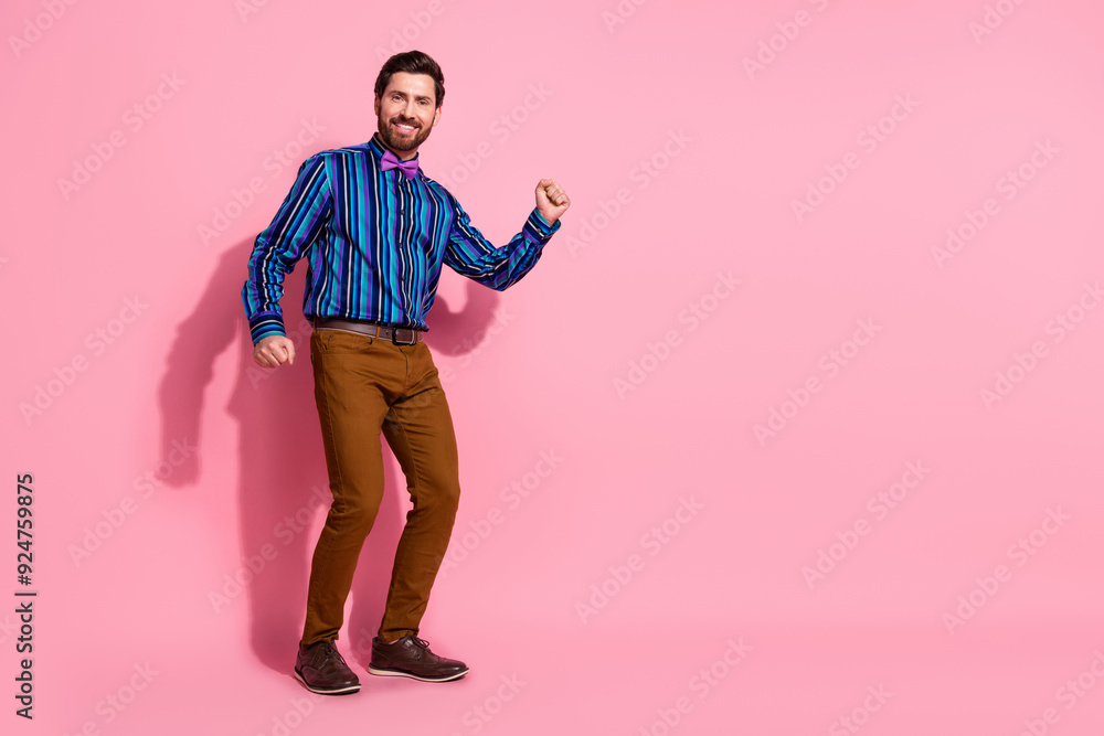 Fototapeta premium Full length photo of cheerful crazy elegant groomed man wear stylish clothes empty space isolated on pink color background