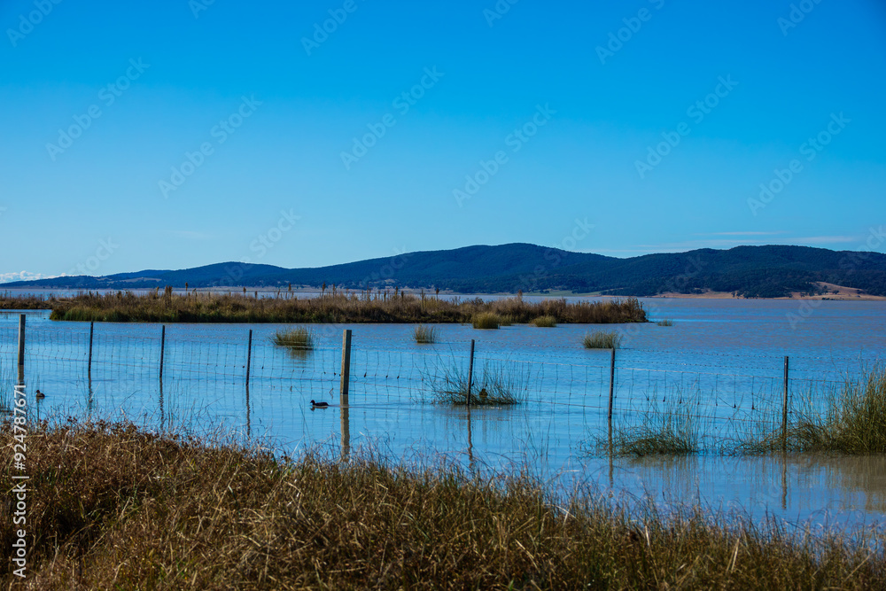 The photo was taken at Lake George, showcasing the scenery by the lake The photo was taken at Lake George, showcasing the scenery by the lake