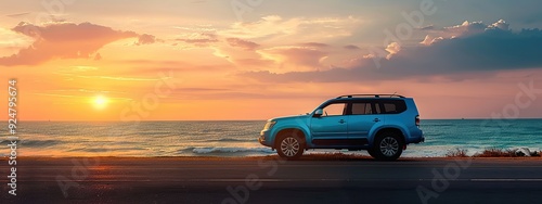 a blue suv car parked on the beach at sunset