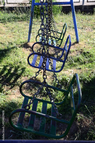 Old swing abandoned among the vegetation