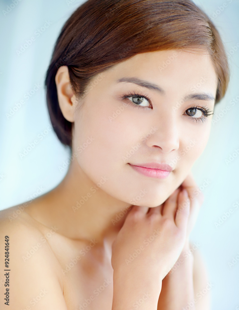 Asian woman, face and touch for skincare, dermatology and beauty in studio with healthy skin. Female person, portrait and hygiene routine on blue background for facial treatment, self care and glow Asian woman, face and touch for skincare, dermatology and beauty in studio with healthy skin. Female person, portrait and hygiene routine on blue background for facial treatment, self care and glow