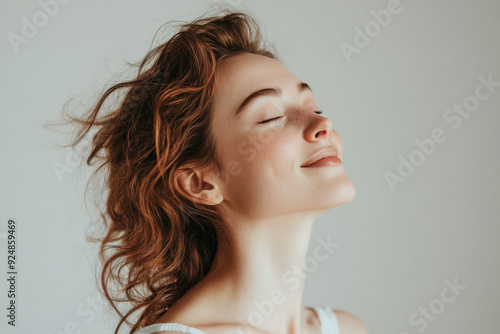 A close up of a woman's face with tattoos and her eyes closed