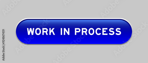 Blue color capsule shape button with word work in process on gray background