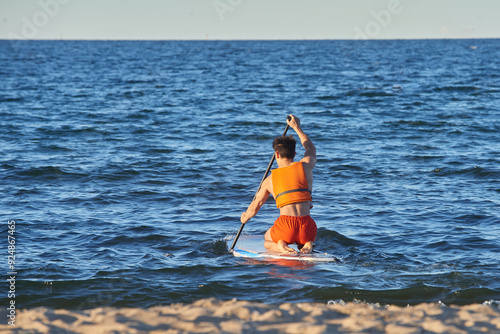 A man is sailing on a supp at sea