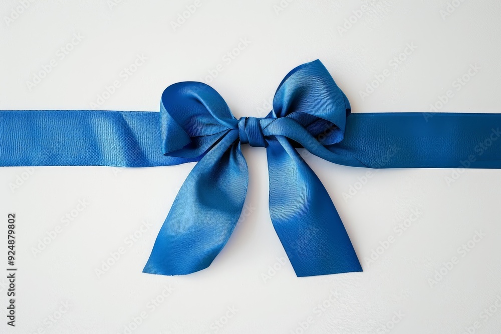 Blue ribbon tied in a bow is laying on a white background Blue ribbon tied in a bow is laying on a white background