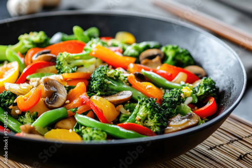 A colorful veggie stir-fry served in a deep, black wok.