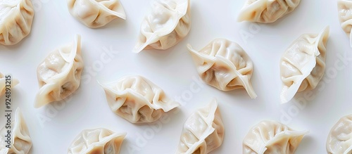 Many isolated dumplings neatly arranged with copy space image on a white surface