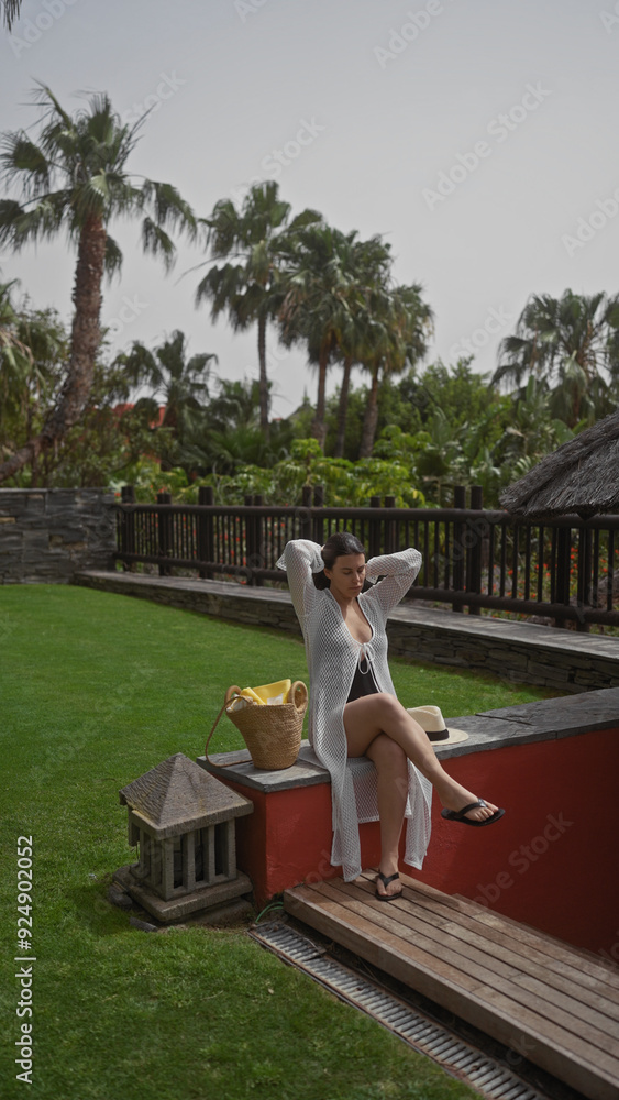 A relaxed hispanic woman enjoys leisure time at a tropical balinese resort, exuding elegance and tranquility. A relaxed hispanic woman enjoys leisure time at a tropical balinese resort, exuding elegance and tranquility.