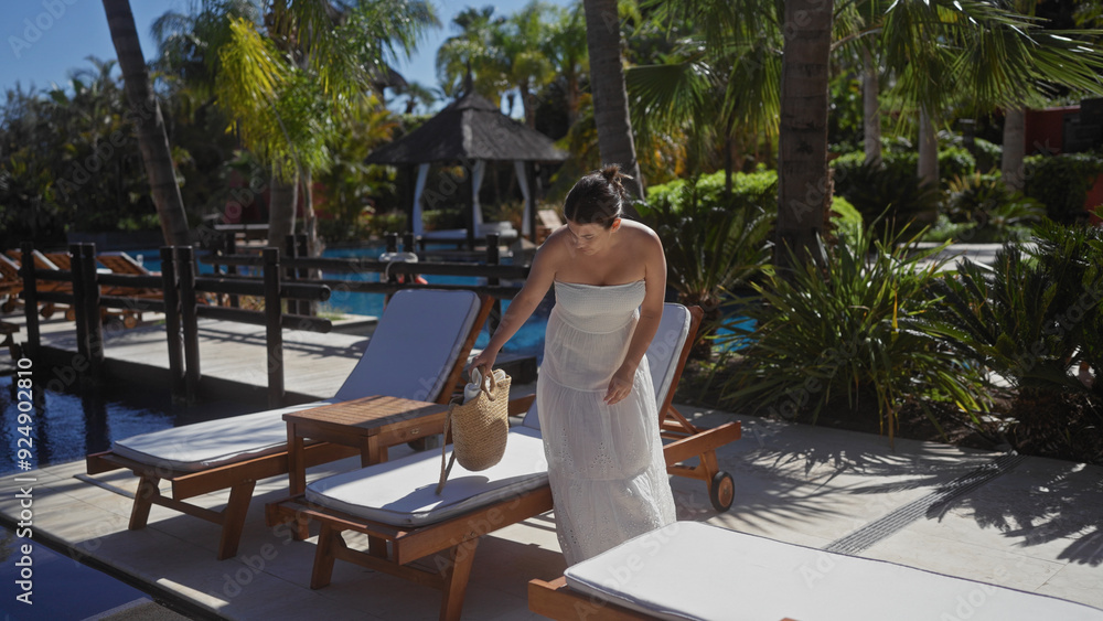 A young woman in a white dress by a tropical resort pool in bali, preparing to lounge under the sun. A young woman in a white dress by a tropical resort pool in bali, preparing to lounge under the sun.