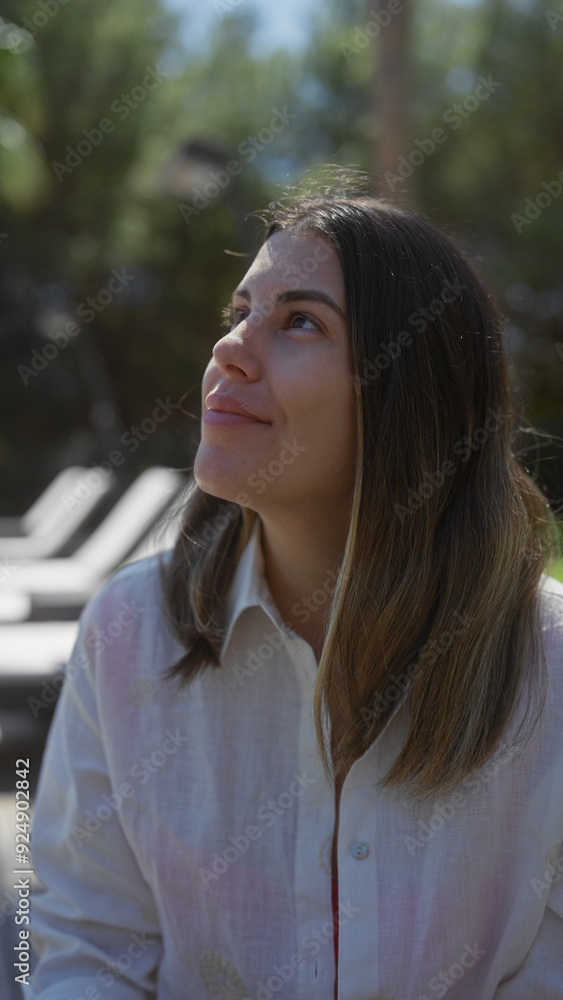 A young hispanic woman enjoys a serene moment outdoors at a bali resort, encapsulating beauty and tranquility. A young hispanic woman enjoys a serene moment outdoors at a bali resort, encapsulating beauty and tranquility.