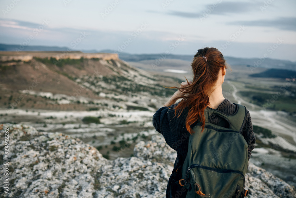 adventure awaits woman with backpack gazes over scenic valley from mountain summit adventure awaits woman with backpack gazes over scenic valley from mountain summit