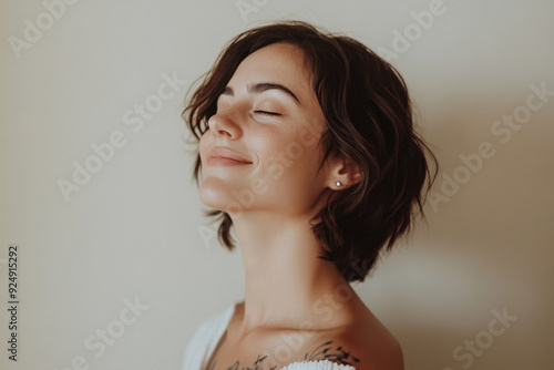 A close up of a woman's face with tattoos and her eyes closed