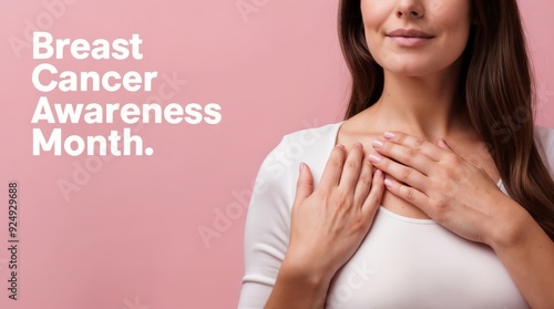 Woman touching her breast, ribbon symbolizing breast cancer, with phrase Breast Cancer Awareness Month, light pink background.